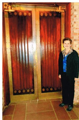 Tina Sorrell in front of the mahogany doors.