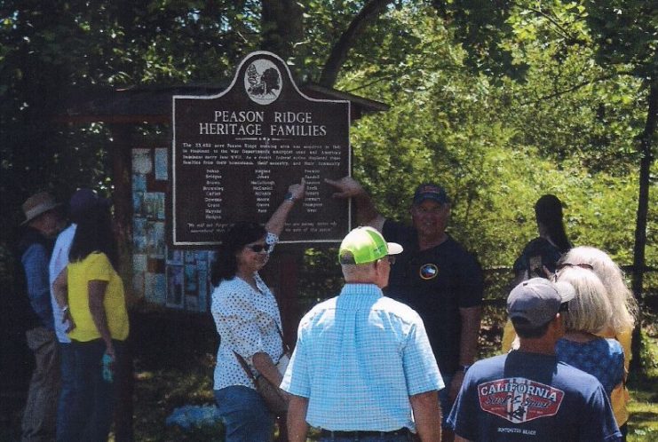 Proud Peason Ridge Heritage Family members point to the names of their ancestors family names on the historical marker located at Peason Memorial Park. (Kim Wallace Photo)